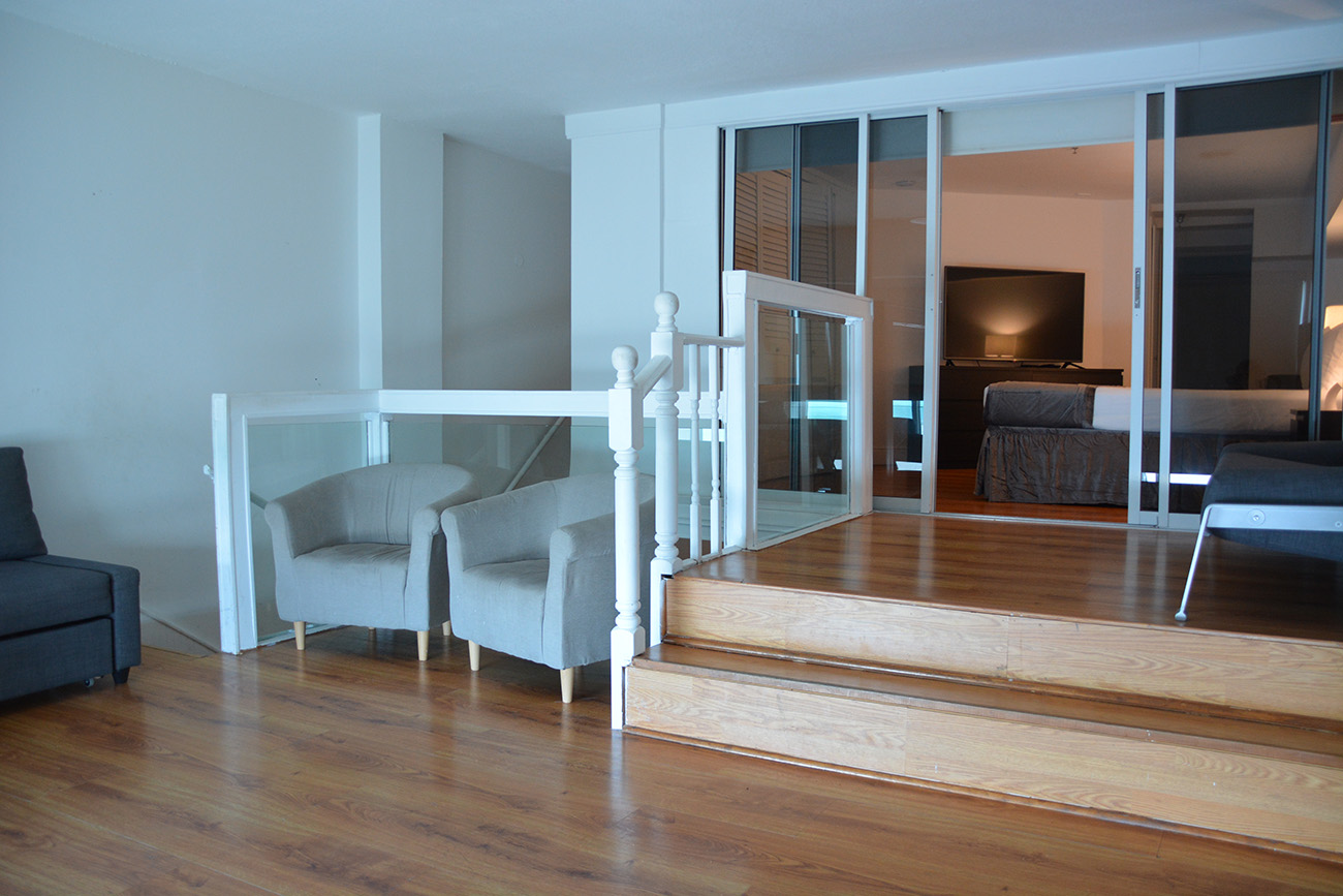 Duplex Ocean View, Second level with wooden floor, lounge chairs and access to the bedroom